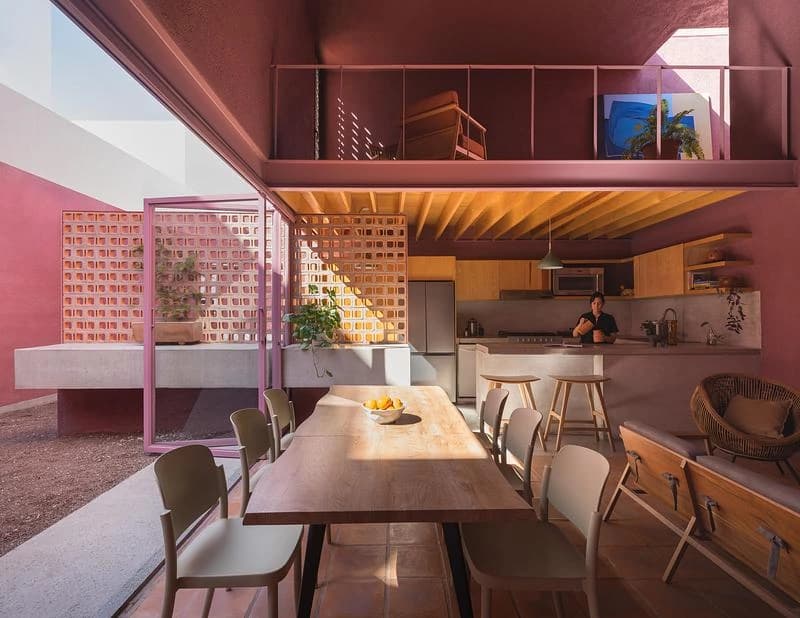 Dining space beneath the mezzanine facing the open courtyard · LGM Studio · via v2com