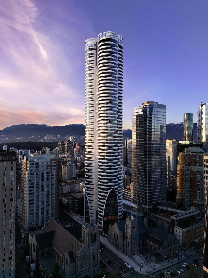 The Butterfly residential tower rises above the First Baptist Church complex in Vancouver at dusk.