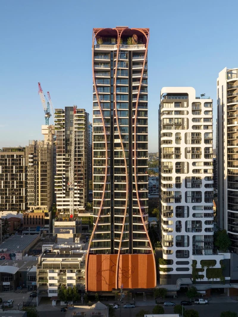 Upper House seen in the South Brisbane skyline, with curved balcony edges and a timber crown.
