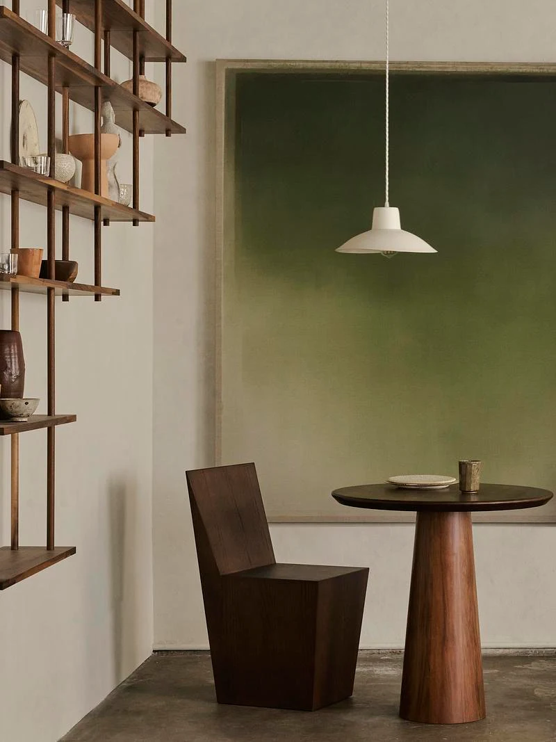 An intimate dining corner against a green wall · Anson Smart · via v2com