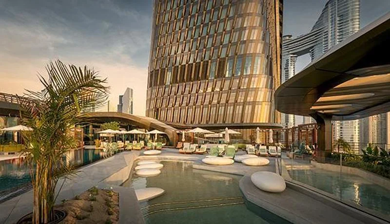 A planted pool terrace at the foot of the tower · Ahmad Alnaji - SARAB · via v2com