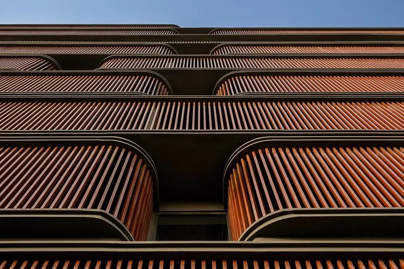 Layered terrace profiles and vertical facade fins · Vinay Panjwani · via v2com