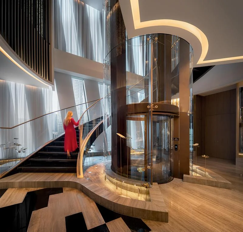 Curved interior forms around a lift and stair · Ahmad Alnaji - SARAB · via v2com