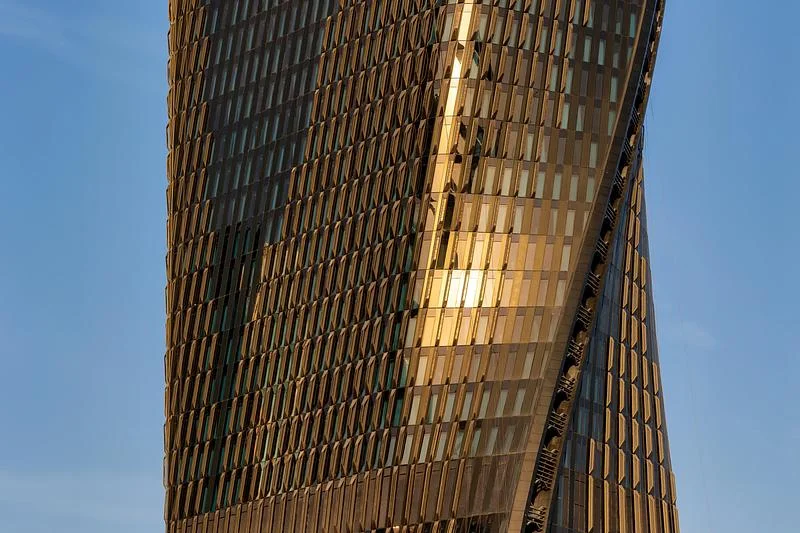 Sunlight catches the folded ceramic facade · Ahmad Alnaji - SARAB · via v2com