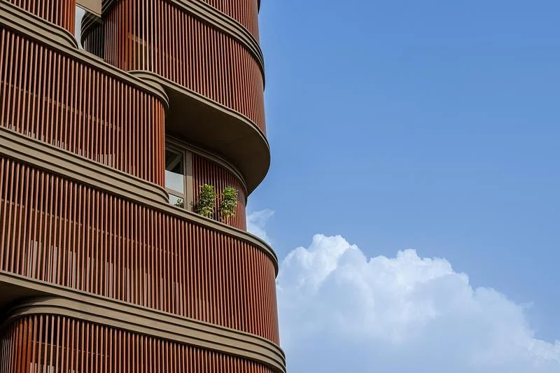 A planted terrace above the rounded screen · Vinay Panjwani · via v2com