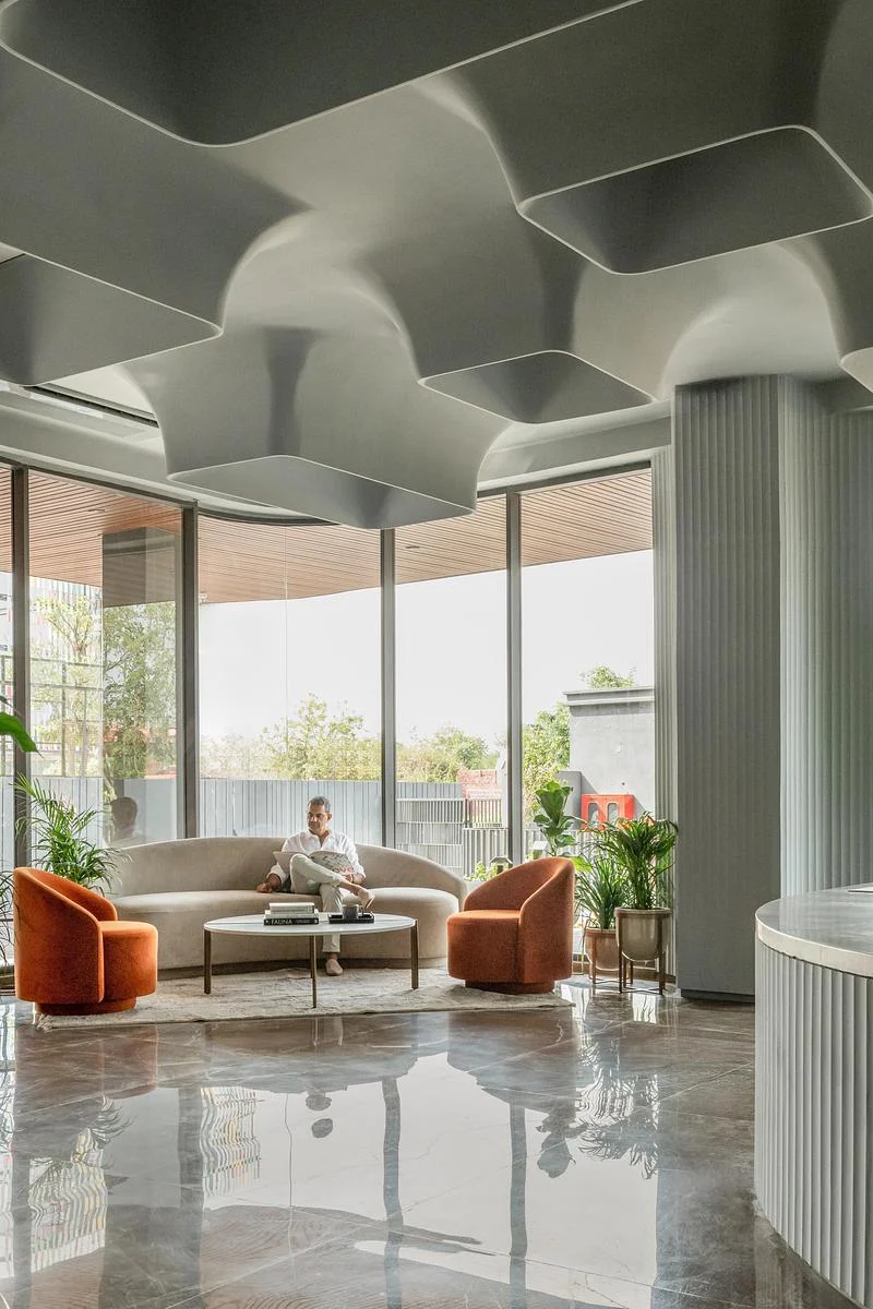 Curved ceiling forms and the glazed entrance lounge · Vinay Panjwani · via v2com
